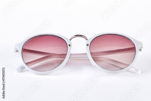 Round sunglasses with white rim. Fashion sunglasses with red glass and white plastic rim isolated on white background. Female fashion accessory.