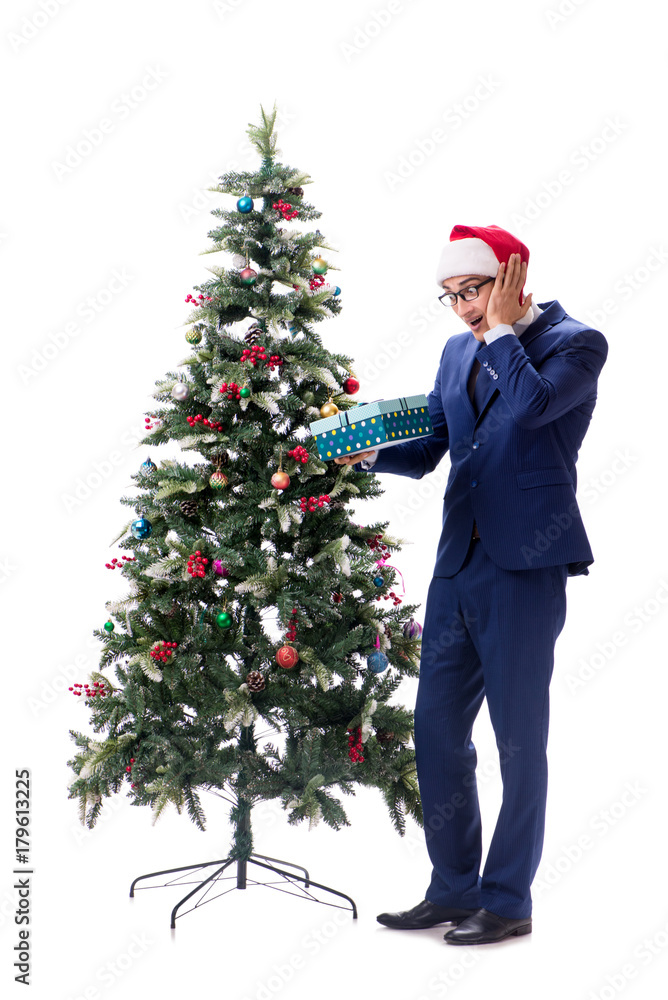 Businessman decorating christmas tree isolated on white Businessman decorating christmas tree isolated on white