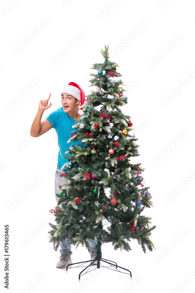 Young man decorating christmas tree isolated on white Young man decorating christmas tree isolated on white