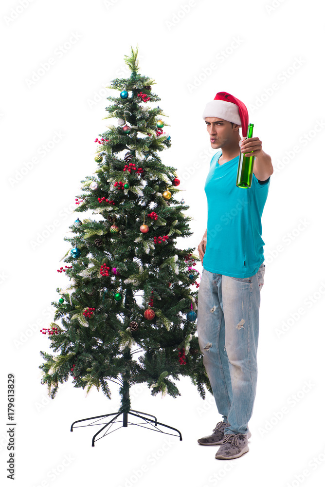 Young man decorating christmas tree isolated on white Young man decorating christmas tree isolated on white