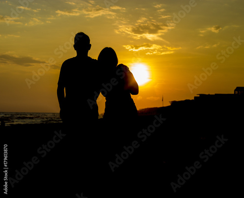 couple silhouetted by sunset