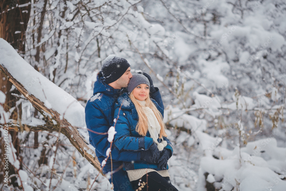 Happy Couple Having Fun and Embracing Outdoors in Snow Park. Winter Vacation
