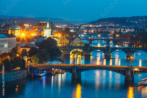 View of bridges with historic Charles Bridge and Vltava river at night in Prague, Czech Republic