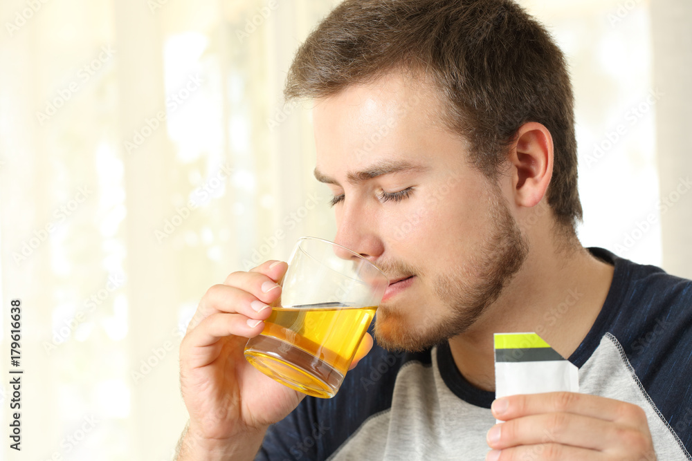 Man drinking a medicine Man drinking a medicine