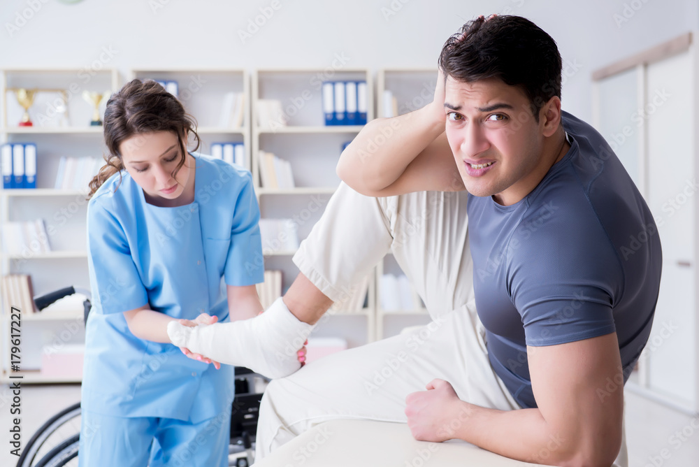 Doctor and patient during check-up for injury in hospital Doctor and patient during check-up for injury in hospital