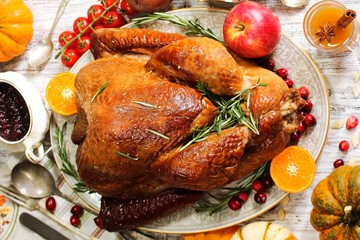 Homemade Thanksgiving Turkey with sides gravy cranberry sauce and autumn vegetables top view