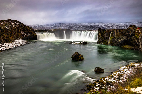 Godafoss Water Fall in Iceland during Winter snow frozen cloudy photo