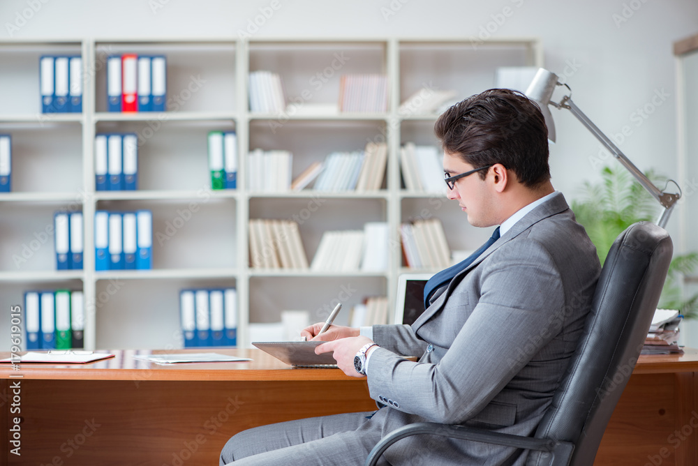 Young businessman working in the office Young businessman working in the office