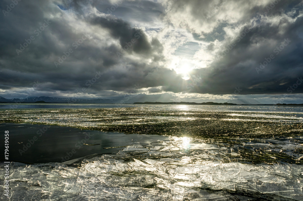 Winter Landscape frozen lake with ice floes and cloudy sky in Ic Winter Landscape frozen lake with ice floes and cloudy sky in Ic