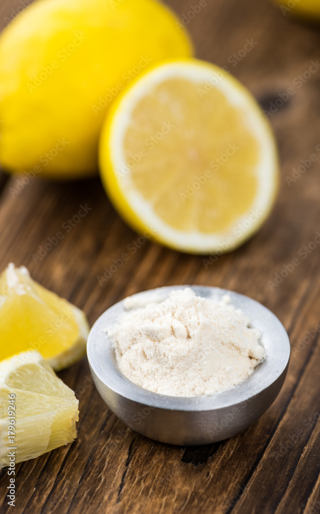 Portion of healthy Lemon powder on an old wooden table (selective focus; close-up shot) Portion of healthy Lemon powder on an old wooden table (selective focus; close-up shot)