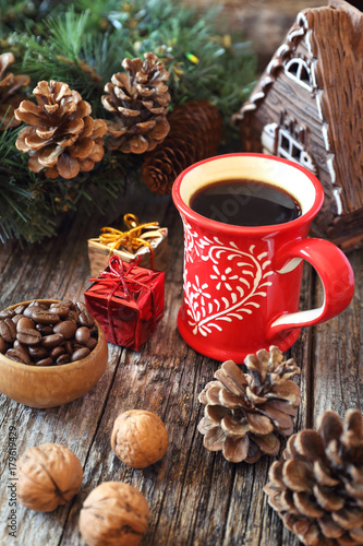 Cup of coffee, coffee beans, pine cones and New-Year tree decorations