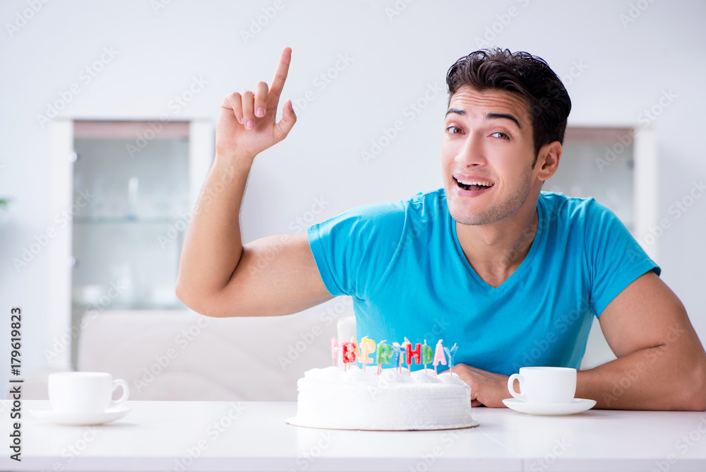 Young man celebrating birthday alone at home Young man celebrating birthday alone at home