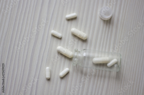 Glass bottle of white pills photo