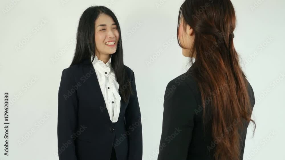 4k of asian businesswomen standing and talking on white background 4k of asian businesswomen standing and talking on white background