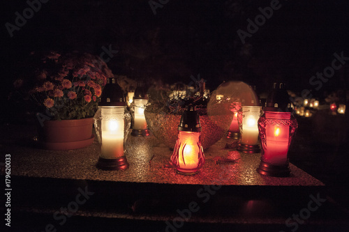 light on the grave at November night