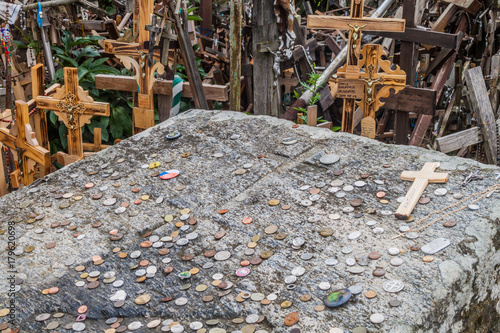 Fototapeta Naklejka Na Ścianę i Meble -  SIAULIAI, LITHUANIA - AUGUST 18, 2016: Detail of crosses and coins at The Hill of Crosses, pilgrimage site in northern Lithuania