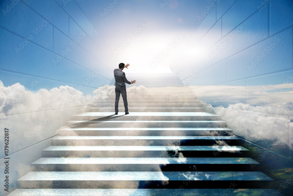 Businessman climbing up challenging career ladder in business co Businessman climbing up challenging career ladder in business co