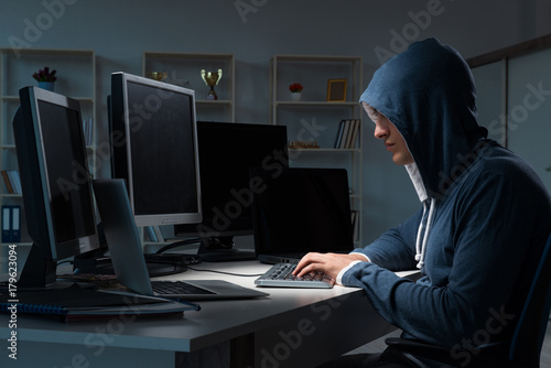 Hacker hacking computer at night