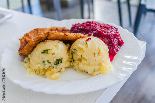 Food in Poland - breaded chicken filet, mashed potatoes and beets photo