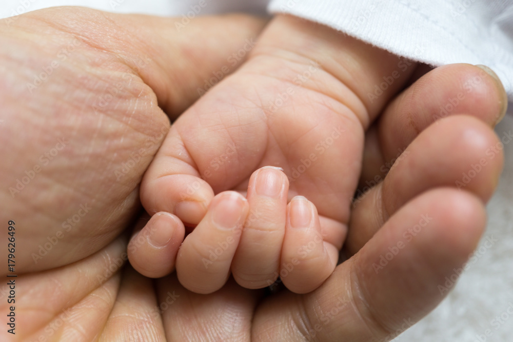 Newborn baby touching his father hand Newborn baby touching his father hand