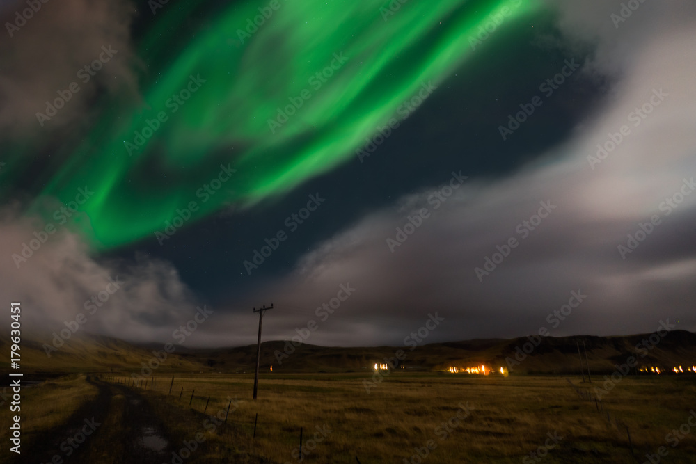 Northern lights Aurora Borealis above landscape in Iceland