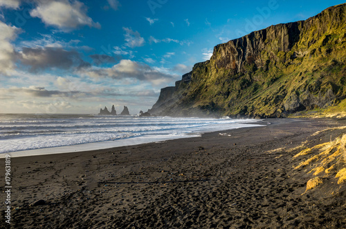 Black Beach and Sea-stacks in Vik Iceland with mountains waves a photo