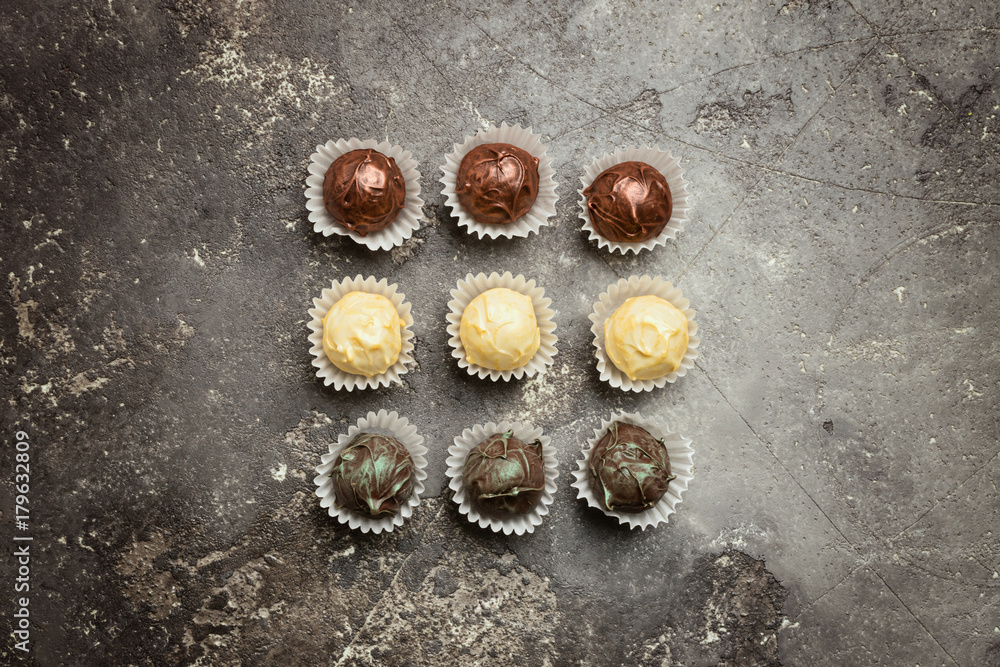 A set of chocolates from different chocolate lies on a gray background. Assorted white and dark chocolate. A set of chocolates from different chocolate lies on a gray background. Assorted white and dark chocolate.