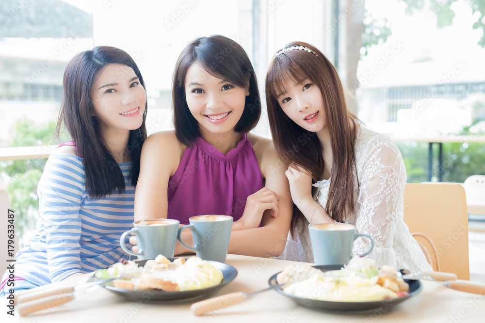 happy woman friends in restaurant