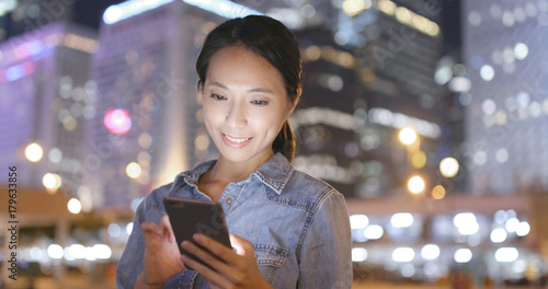 Photography Woman use of mobile phone in Hong Kong city at night