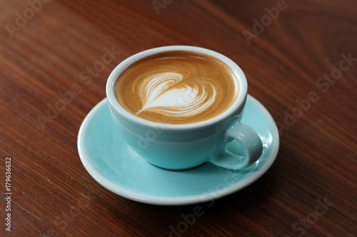 Coffee cup on wood table background with copy space