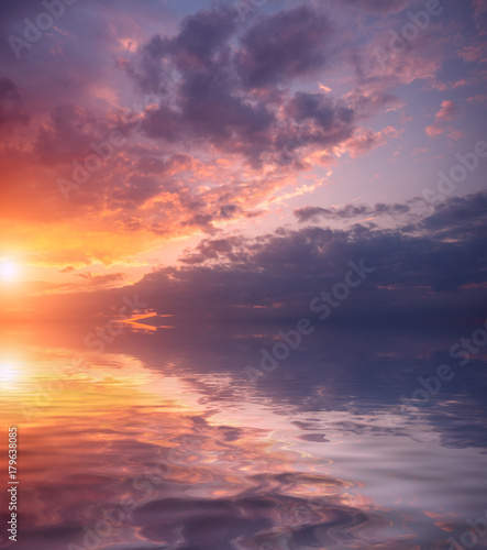 Dawn on a spring day and beautiful bright clouds over the sea.