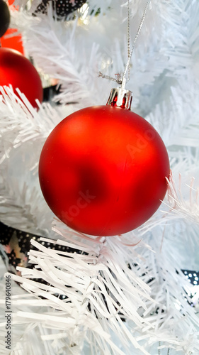 Matt red ornament hanging on a tree