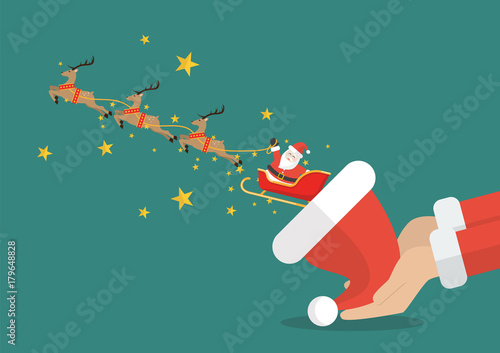 Santa claus with reindeer sleigh flying out of the santa hat