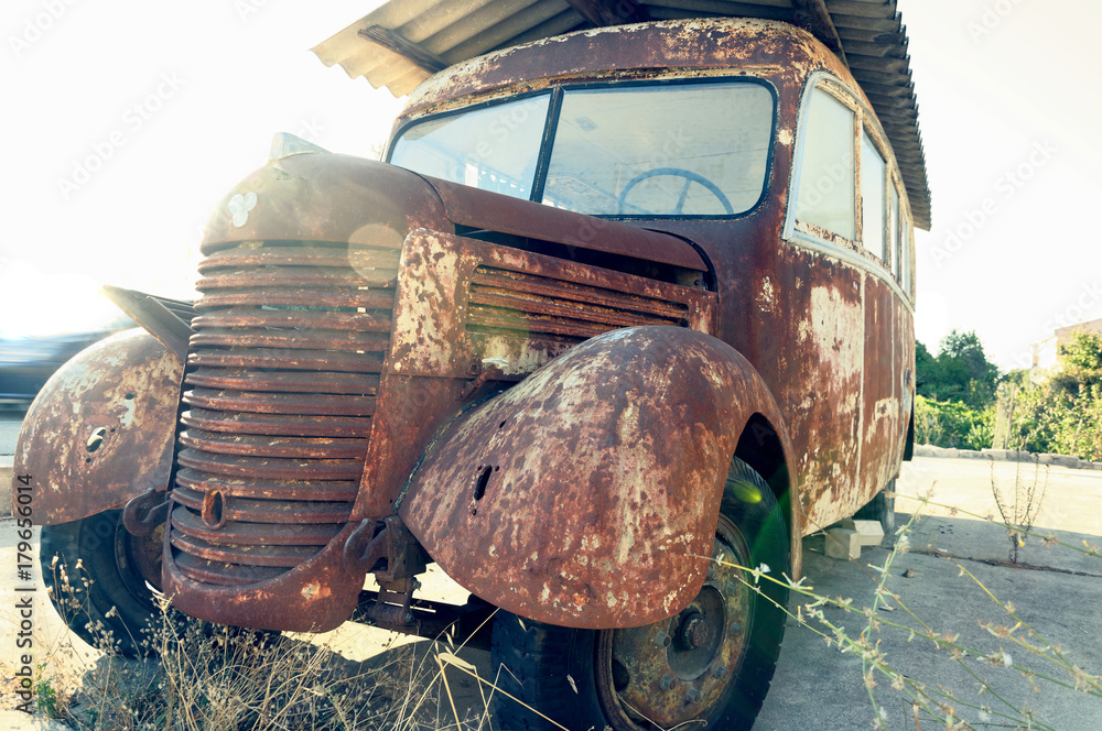 Old rusty bus abandoned at the edge of the road. - obrazy, fototapety, plakaty 