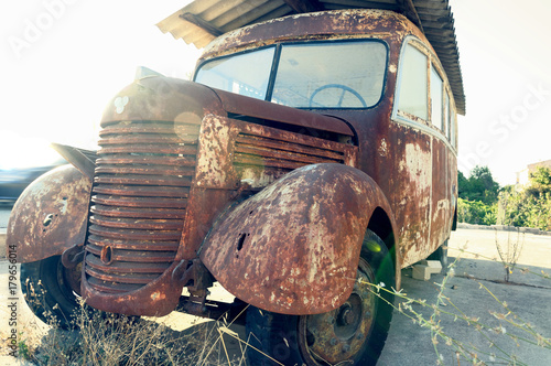 Old rusty bus abandoned at the edge of the road.