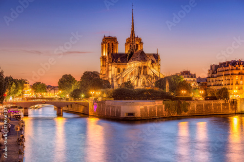 Notre Dame cathedral in Paris, France at night. Scenic skyline at blue hour.