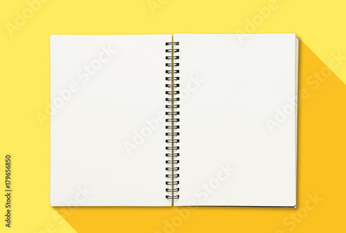 Opened book with empty white paper on yellow background
