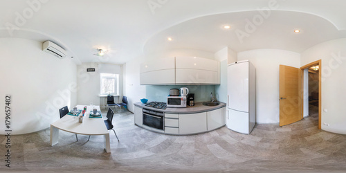 Panorama in interior of modern kitchen in light color style.  Full 360 by 180 degree seamless spherical panorama in equirectangular equidistant projection. VR content photo