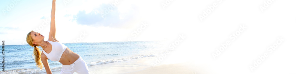 Fototapeta premium Beautiful woman doing yoga exercises by the beach - banner template web