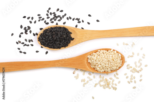 Photos Black and white sesame seeds in a wooden spoon isolated on white background top