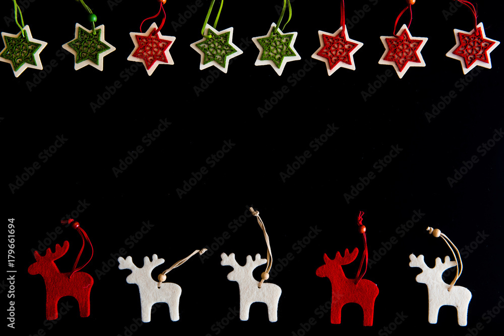 Fototapeta premium Felt rein deers and snowflakes isolated on black