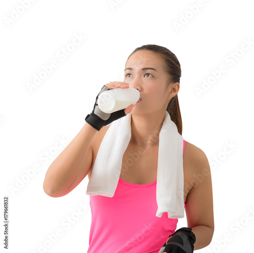 Fitness woman happy smiling holding milk bottle and drinking milk