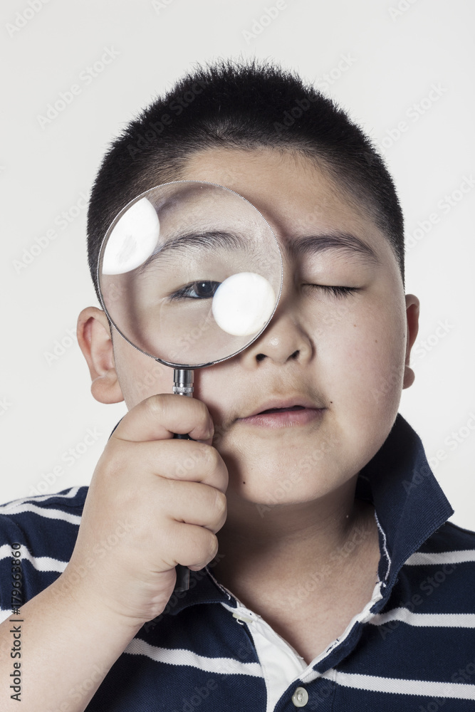 A fat boy hand holding a magnifier(glass) isolated white. A fat boy hand holding a magnifier(glass) isolated white.