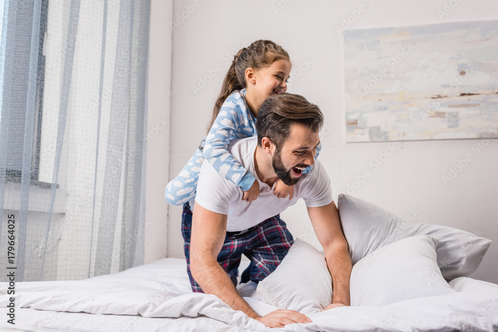 father and daughter playing in bed father and daughter playing in bed