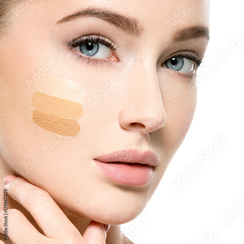 Young woman with cosmetic foundation on skin.