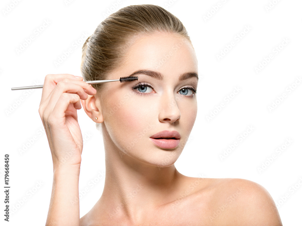 Girl makes makeup. Woman apply mascara on eyelashes