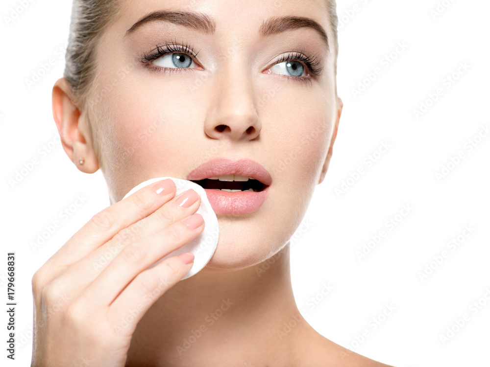 Girl removes makeup cotton ball from face Girl removes makeup cotton ball from face