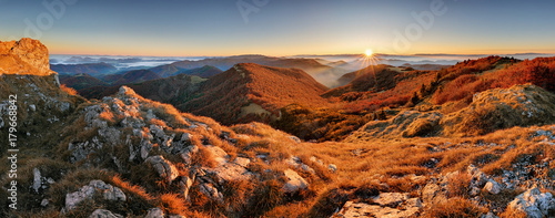 Panorama of sunset in a Carpathian mountain valley with wonderful gold light on a hills © TTstudio