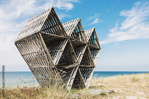 Old abandoned wooden geometric sculpture on wild beach in Juodkrante, Lithuania