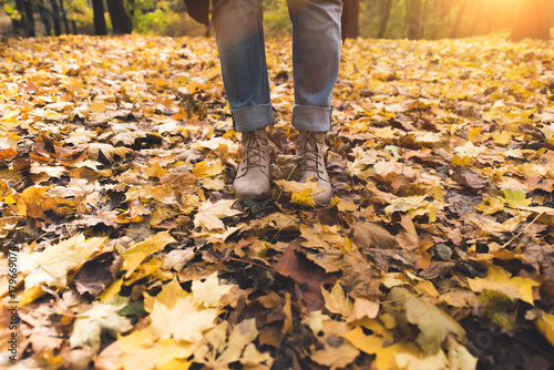 person standing on fallen leaves